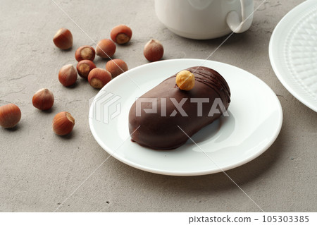 Delicious chocolate biscuit cakes with nuts on white plate 105303385