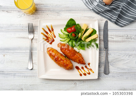 Chicken Adana kebap served with vegetables on white plate Chicken Adana kebap served with vegetables on white plate 105303398