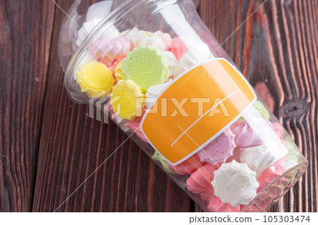 Colorful sweet meringue cookies assortment on wooden table Colorful sweet meringue cookies assortment on wooden table 105303474