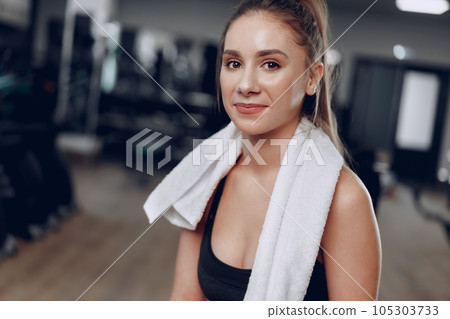 Portrait of a young sporty caucasian woman training in a fitness club Portrait of a young sporty caucasian woman training in a fitness club 105303733
