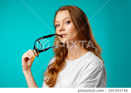 Studio portrait of beautiful young casual woman thinking 105303746