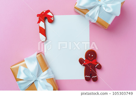 Mock up of holiday greeting card with gingerbread cookies on pink background 105303749