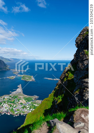 Amazing view from Reinebringen view point. Mountains and blue sea at Lofoten islands. Scenery of Reine fishing village 105304239