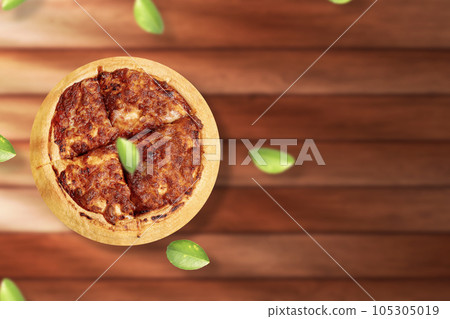 Margherita pizza on wooden table background. Fly lemon green leaf. Top view with copy space Margherita pizza on wooden table background. Fly lemon green leaf. Top view with copy space 105305019