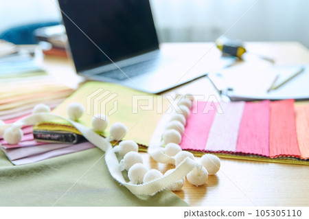 Workplace of designer, decorator, samples of fabrics and accessories recording notebook on table Workplace of designer, decorator, samples of fabrics and accessories recording notebook on table 105305110