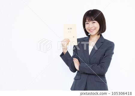 A woman in her thirties in a suit with a salary bag in front of a white background A woman in her thirties in a suit with a salary bag in front of a white background 105306418