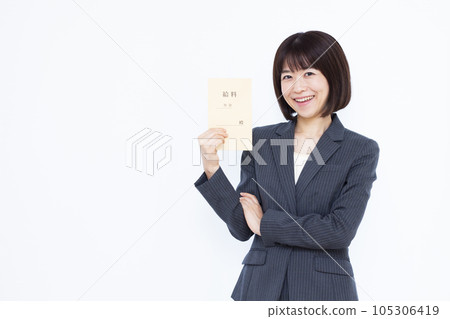 A woman in her thirties in a suit with a salary bag in front of a white background A woman in her thirties in a suit with a salary bag in front of a white background 105306419