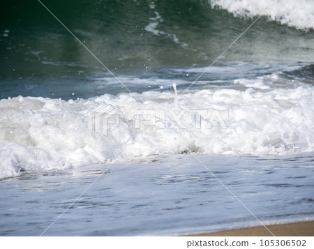 Waves and splashes crashing on the sandy beach. high speed shutter. 105306502