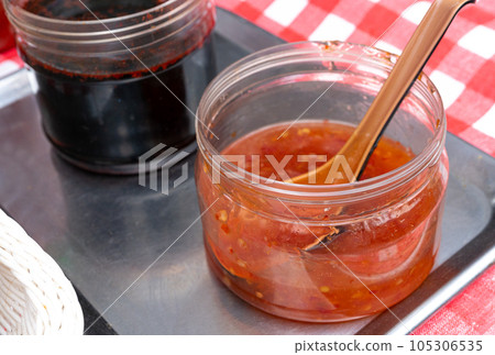 Sweet Chili Sauce, Red Asian Dip, Hot Thai Sauce with Spices and Sugar, Sweet Chinese Chili Sauce 105306535