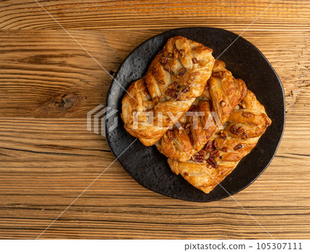 Maple Pecan Puff Pastry, Danish Plaits Pastries with Maple Syrup and Pecan Nuts, Breakfast Bakery Maple Pecan Puff Pastry, Danish Plaits Pastries with Maple Syrup and Pecan Nuts, Breakfast Bakery 105307111