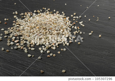 Crushed Quartz Pile, White Stone Pieces, Grit Sand, Decorative Rocks Texture on Black Background 105307296