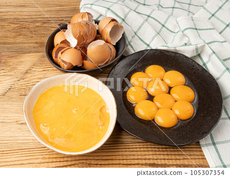 Egg Yolks in Bowl, Fresh Chicken Egg Yolk Separated from Whites for Cooking Recipe, Organic Yolks Top View 105307354