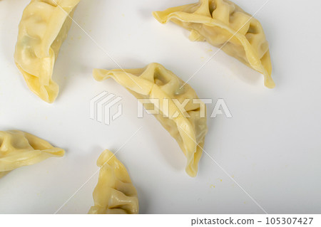 Gyoza Chinese Dumplings on WHite, Vegetable Jiaozi, Chicken Momo Pile, Asian Gyoza Group 105307427