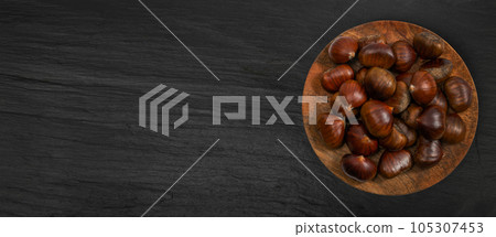 Chestnuts on Black Background, Edible Sweet Chestnut Pile, Autumn and Christmas Veggie Food 105307453