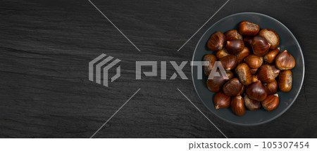 Chestnuts on Black Background, Edible Sweet Chestnut Pile, Autumn and Christmas Veggie Food Chestnuts on Black Background, Edible Sweet Chestnut Pile, Autumn and Christmas Veggie Food 105307454