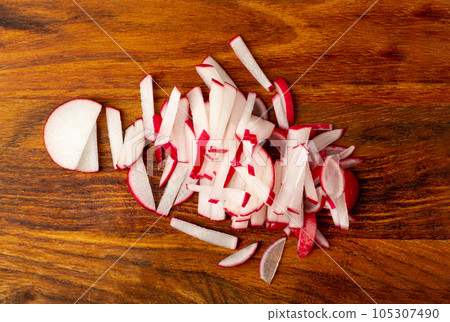 Sliced Radish Roots, Red Root Cuts, Red Radishes Slice Pile, Radis Pieces on Wood Background 105307490