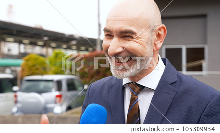 Foreign businessman being interviewed on the street corner 105309934