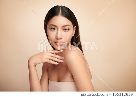 Beautiful young asian woman with clean fresh skin on beige background, Face care, Facial treatment, Cosmetology, beauty and spa, Asian women portrait. Beautiful young asian woman with clean fresh skin on beige background, Face care, Facial treatment, Cosmetology, beauty and spa, Asian women portrait. 105312639