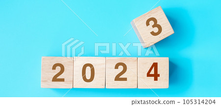 wooden cube block with 2024 text on blue background. Resolution, plan, review, goal, start and New Year holiday concepts 105314204