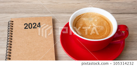 2024 notebook and coffee cup on wood table, Top view and copy space. Xmas, Happy New Year, Goals, Resolution, To do list, Strategy and Plan concept 105314232