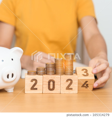 Happy New Year with piggy bank and flipping 2023 change to 2024 block. Resolution, Goals, Plan, Action, Money Saving, Retirement fund, Pension, Investment and Financial concept 105314279