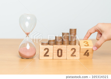 Happy New Year with sandglass and flipping 2023 change to 2024 block. Resolution, Goals, Plan, Action, Money Saving, Retirement fund, Pension, Investment and Financial concept 105314321