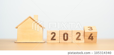 flip 2023 to 2024 block with house model. real estate, Home loan, tax, investment, financial, savings and New Year Resolution concepts 105314340