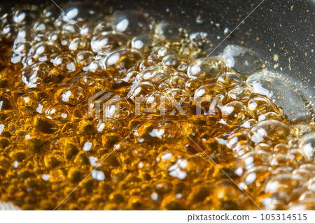 A close-up of the cooking scene where the dashi soup is put in a frying pan and boiled. 105314515