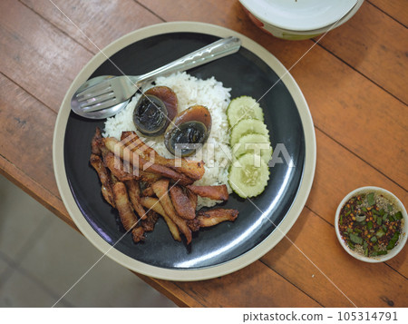 Deep-fried pork belly with fish sauce , preserved egg Deep-fried pork belly with fish sauce , preserved egg 105314791
