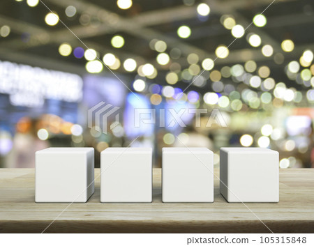 Four white block cubes on wooden table Four white block cubes on wooden table 105315848