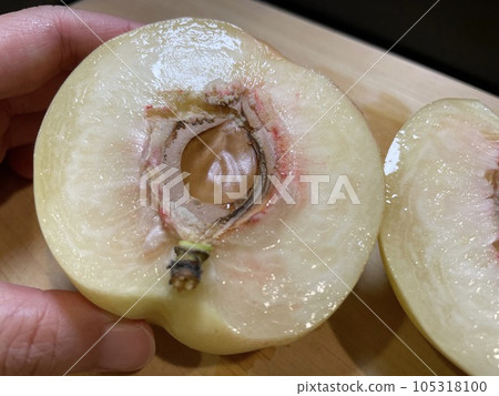 Cross-section of a Shimizu White Peach: Juicy flesh and seed. Cross-section of a Shimizu White Peach: Juicy flesh and seed. 105318100