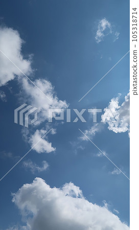Heavenly white clouds on the blue sky with the sun appeared perfect for multimedia texture or background and content creation Heavenly white clouds on the blue sky with the sun appeared perfect for multimedia texture or background and content creation 105318714