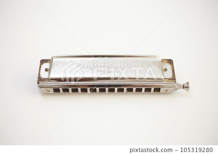 An old harmonica photographed on a white background 105319280