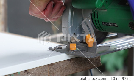 smooth movements with the saw along the marked cutting line on the chipboard. smooth movements with the saw along the marked cutting line on the chipboard. 105319733