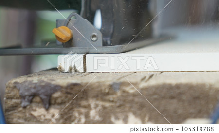 smooth movements with the saw along the marked cutting line on the chipboard. smooth movements with the saw along the marked cutting line on the chipboard. 105319788