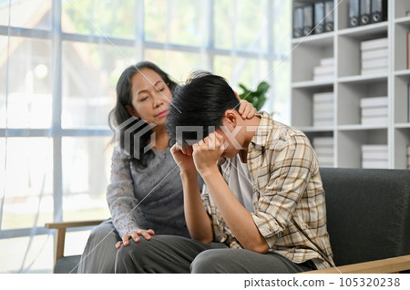 A kind and caring Asian grandma touched her grandson's head with love and kindness 105320238