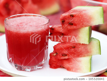 Watermelon juice with sliced fruit on white plate Watermelon juice with sliced fruit on white plate 105320841