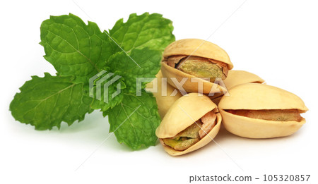 Pistachios with green mint leaves Pistachios with green mint leaves 105320857