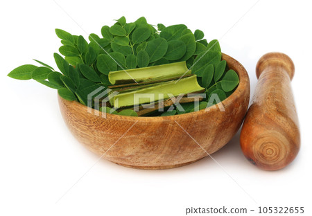 Moringa leaves and bark and mortar pestle Moringa leaves and bark and mortar pestle 105322655