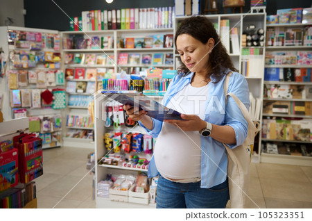Pregnant woman artist holding metal case with color pencils, buying school stationery for the start of new academic year Pregnant woman artist holding metal case with color pencils, buying school stationery for the start of new academic year 105323351