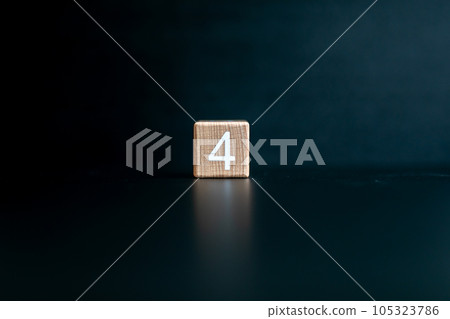 Wooden block written "4" with a Black background. 105323786