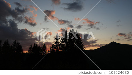 Outlines of trees and a peak at sunset seen from Blattipass. Outlines of trees and a peak at sunset seen from Blattipass. 105324680