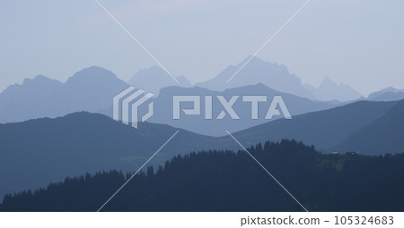 Blue mountain ranges in the morning light, Switzerland. 105324683
