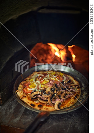 Pizza in a bread wood fired oven Pizza in a bread wood fired oven 105326308