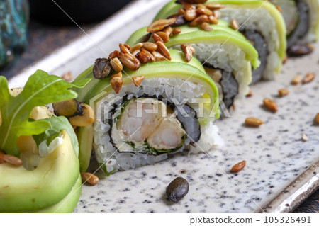 Sushi, delicious Japanese cuisine. Rolls of delicious sushi on a plate 105326491