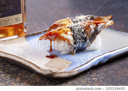 Sushi, delicious Japanese cuisine. Rolls of delicious sushi on a plate 105326493