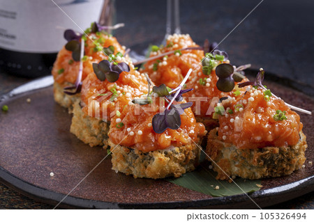 Sushi, delicious Japanese cuisine. Rolls of delicious sushi on a plate 105326494
