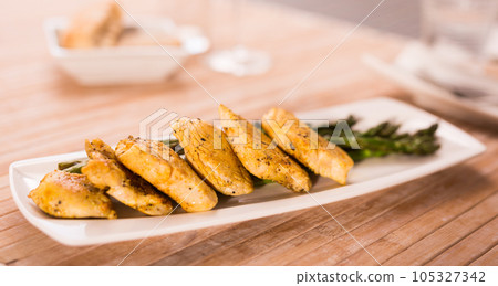 fried chicken breast pieces with asparagus on white plate fried chicken breast pieces with asparagus on white plate 105327342