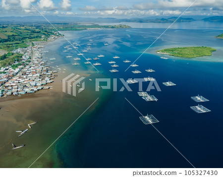 Local village and boats in ocean on Sumbawa island. Aerial view. 105327430