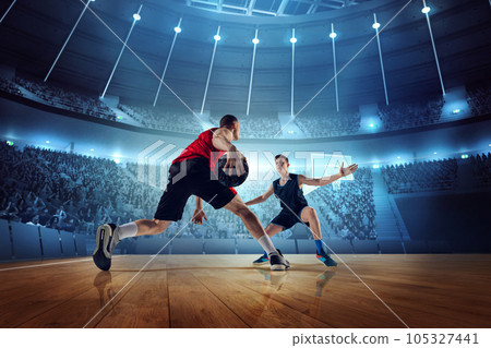 Motivated and competitive young men, basketball players in motion during match, game playing at 3D arena with flashlights 105327441